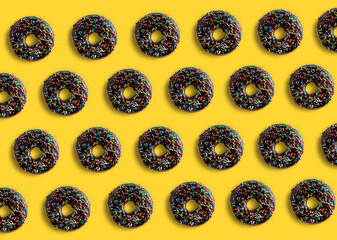 Chocolate covered donuts pattern on yellow pop background. summer concept