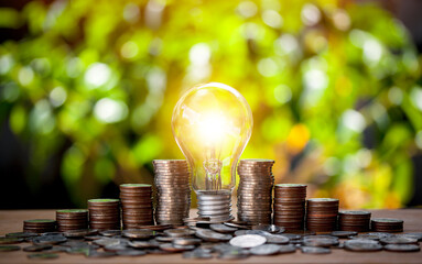Stack of coins and money with light for saving concept investment mortgage fund finance and...
