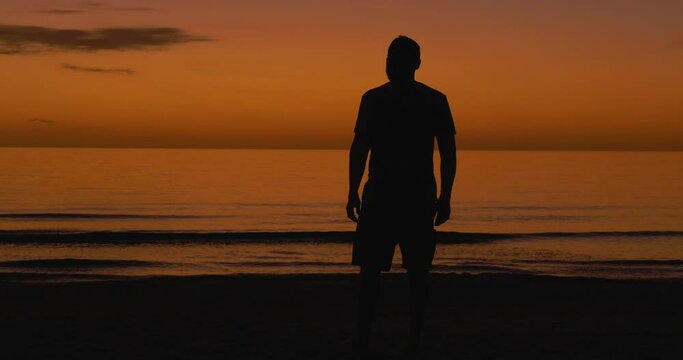 498 Silhouette of a man looking into the distance after the sun has set