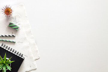 Copy space with handmade paper and sketchbook.