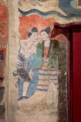 Ancient wall fresco painting, love whispering, in ordinance chapel at Wat Phumin. Famous tourist attraction and destination.