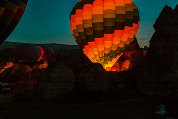 Obraz premium Hot air balloons at sunrise preparing for flight.