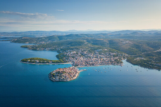 Aerial view of Primosten old town on the islet, amazing sunny landscape, Dalmatia, Croatia. Famous tourist resort on Adriatic sea coast, outdoor travel background