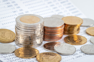 Coins stack on bank account book, growing money saving concept
