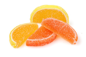 Naklejka na ściany i meble Composition of marmalade candy in shape of citrus fruits wedges. Yellow and orange Jelly sweet candies isolated on white background. With Copy Space. Close-up. Full depth of field.