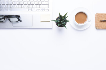 Flat lay, Workplace with laptop, coffe and office supplies on withe desk. With copy space.