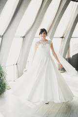 Fototapeta premium Portrait of stunning bride with long hair posing with great bouquet