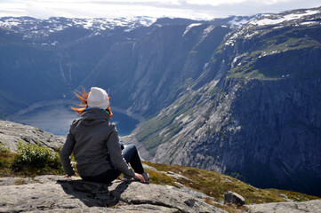 Girl and the lake in the mountains on the way to Trolltunga 