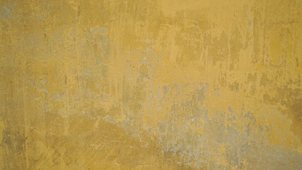 Old rustic scratched concrete yellow wall texture background