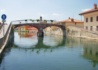 Obraz premium cityscape of Gaggiano, a village crossed by the Naviglio Grande, a navigable canal on the outskirts of Milan