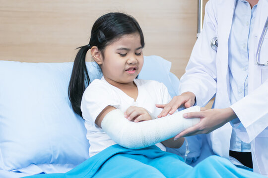 Little girl wearing cast on her broken arm