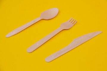 cutlery fork spoon knife on a yellow background. eco packaging or delivery concept.