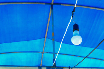 LED light  bulb hanging in a tent .