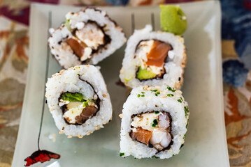 Japanese sushi food is excellent. Maki and rolls with tuna, salmon and avocado. Top view of assortment of sushi, all you can eat a la carte. Rainbow sushi roll, uramaki, hosomaki and nigiri.