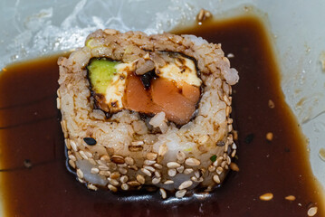 Japanese sushi food is excellent. Maki and rolls with tuna, salmon and avocado. Top view of sushi roll. wasabi.Selective focus.