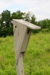 A close view of the old wooden birdhouse in the park.