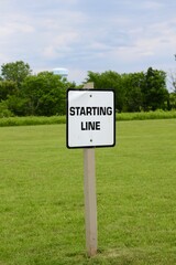 A close view of the black and white starting line sign.