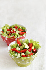 salad with strawberries, avocado, lettuce, green peas.