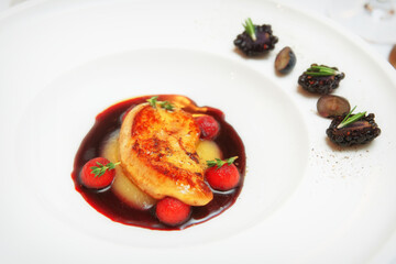 Grilled duck liver in white china plate, toned