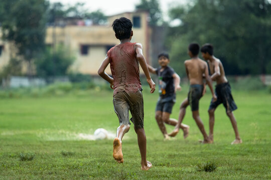 Friends Playing Soccer On Field