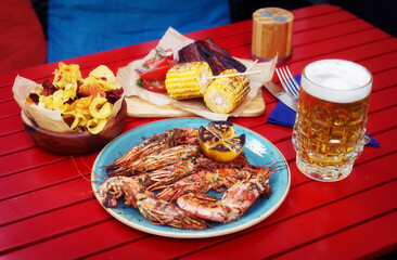 Meat, seafood and potato chips served with beer, toned