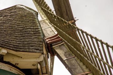 view of a windmill with its large drive shaft and the windmill vane
