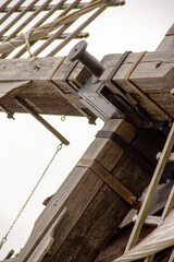 view of a windmill with its large drive shaft and the windmill vane