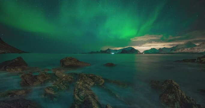 4K,10bit,422,timelapse video of night starry sky with northern light and snow mountain in Lofoten,Norway, northern light shining 