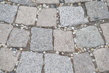 Stone pavement texture. Granite cobblestoned pavement background. Abstract background of old cobblestone pavement close-up. Seamless texture. Perfect tiled on all sides