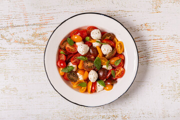 Traditional Caprese salad made of sliced fresh tomatoes, mozzarella cheese and basil