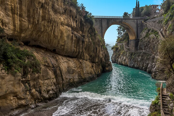Waves break as the sea enters the fjord at Fiordo di Furore on the Amalfi Coast, Italy