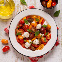 Traditional Caprese salad made of sliced fresh tomatoes, mozzarella cheese and basil