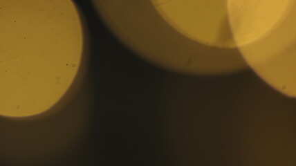 Natural Gold Color Bokeh Particles Effect Photo Overlays Background Glowing Abstract Lens Lights Defocused Circles and Blur Golden Glitter Beautiful Glamour Style. Use Screen Overlay Mode.