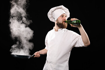 Bearded chef forgot about meal in a frying pan that burns, because he enjoys beer isolated on black background