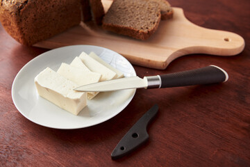 healthy food - fresh bread and feta cheese on a wooden background