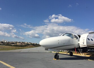 Business jet parked at airport waiting for passenger on sunny day