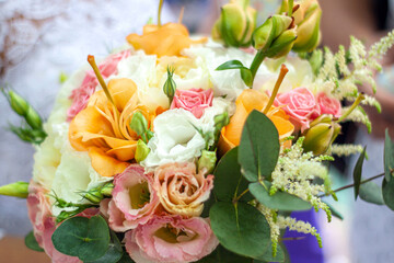Close-up of colorful wedding bouquet of flowers in hands of the bride. Wedding idea concept