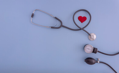 stethoscope, blood pressure monitor, pills on a blue background. the concept of medicine and health care