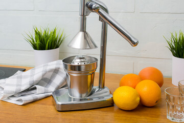 making juice from oranges, fruits and juice, citrus, juicer on the table