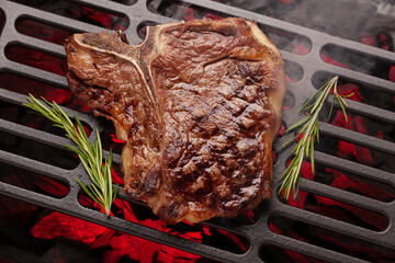 T-bone beef steak cooking on grill