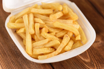 French fries in a plastic box, fast food.
