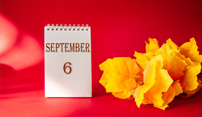 Calendar with the text October 6 on a red background and with a maple leaf