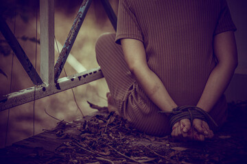 Asian hostage woman Bound with rope at night scene,The thieves kidnapped for ransom,thailand people
