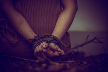 Asian hostage woman Bound with rope at night scene,The thieves kidnapped for ransom,thailand people