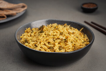 Kichari in a gray dish on a concrete surface