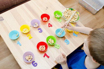 Little child doing simple math exercises. Early education, counting game. Preschool exercise for kids. Sequence from 1 to 10.