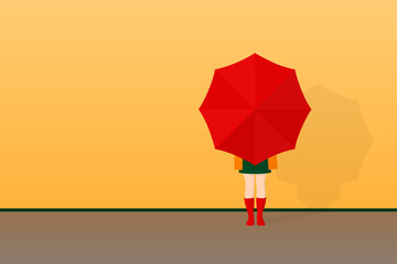 A woman with an umbrella in red rubber boots stands in front of an empty orange wall. Autumn background, postcard, Wallpaper. Banner with empty space for your text.