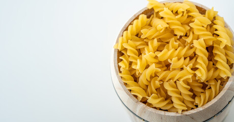Raw dry uncooked Fusilli pasta spaghetti noodle on white background Good for basil tomato pesto sauce Homemade fresh Italian food organic whole wheat vegan spaghetti noodle for a healthy meal