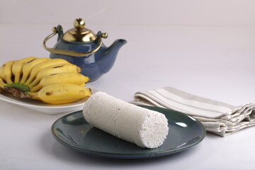 PUTTU or WHITE RICE PITTU ,Kerala special breakfast items made using rice flour which is very healthy and arranged in traditional way with  blue background