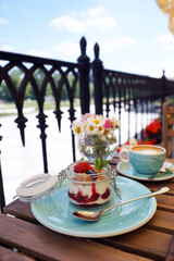 Breakfast with granola on the veranda of the summer restaurant
